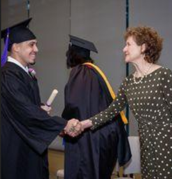 The Literacy Project's Executive Director Judith Roberts, congratulating a graduate