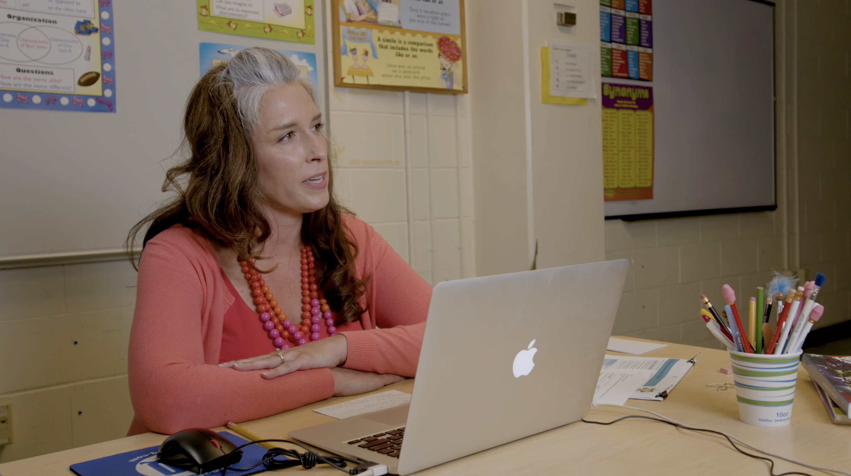 screenshot of teacher at desk