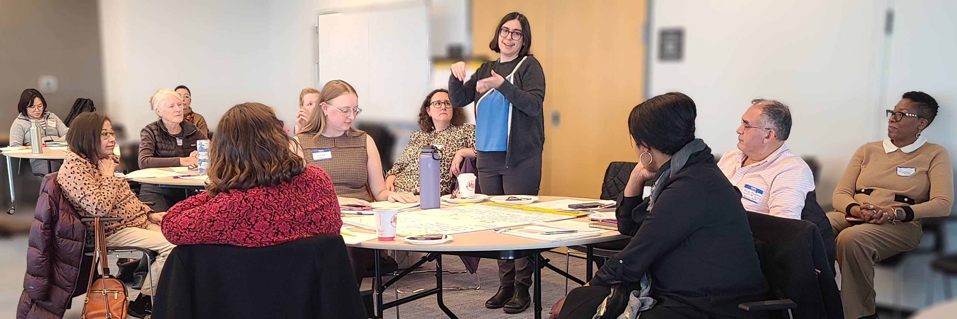 Adults in a class listen to Pesha Black