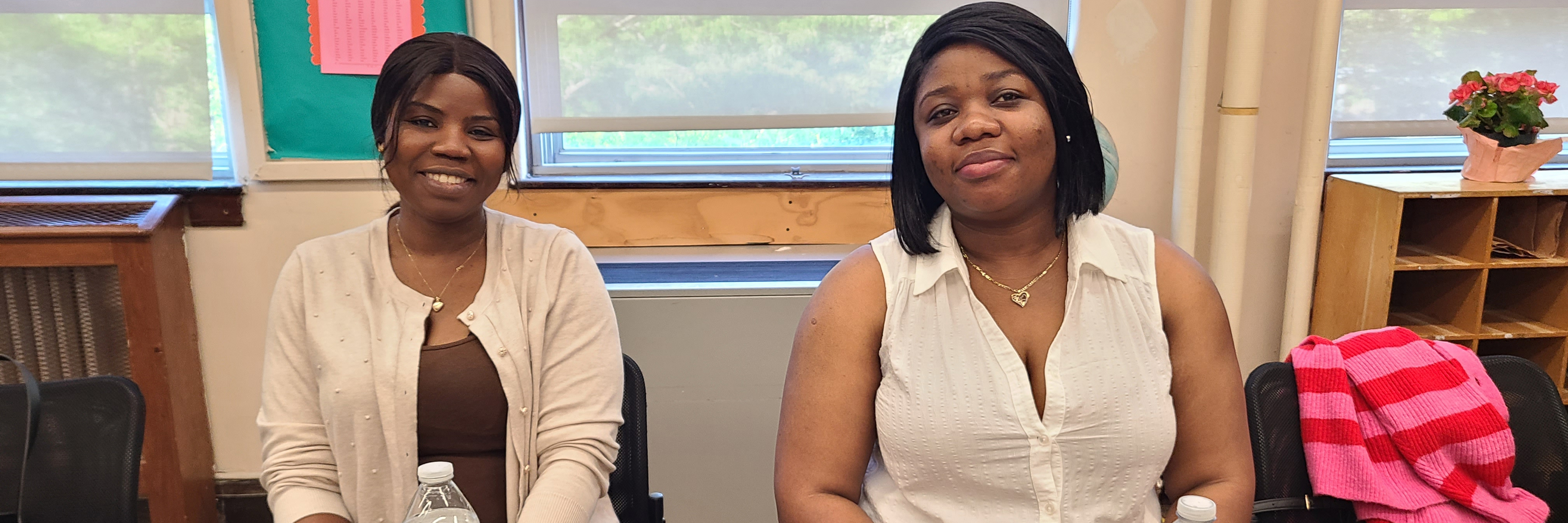 Two adult education students sitting at a table