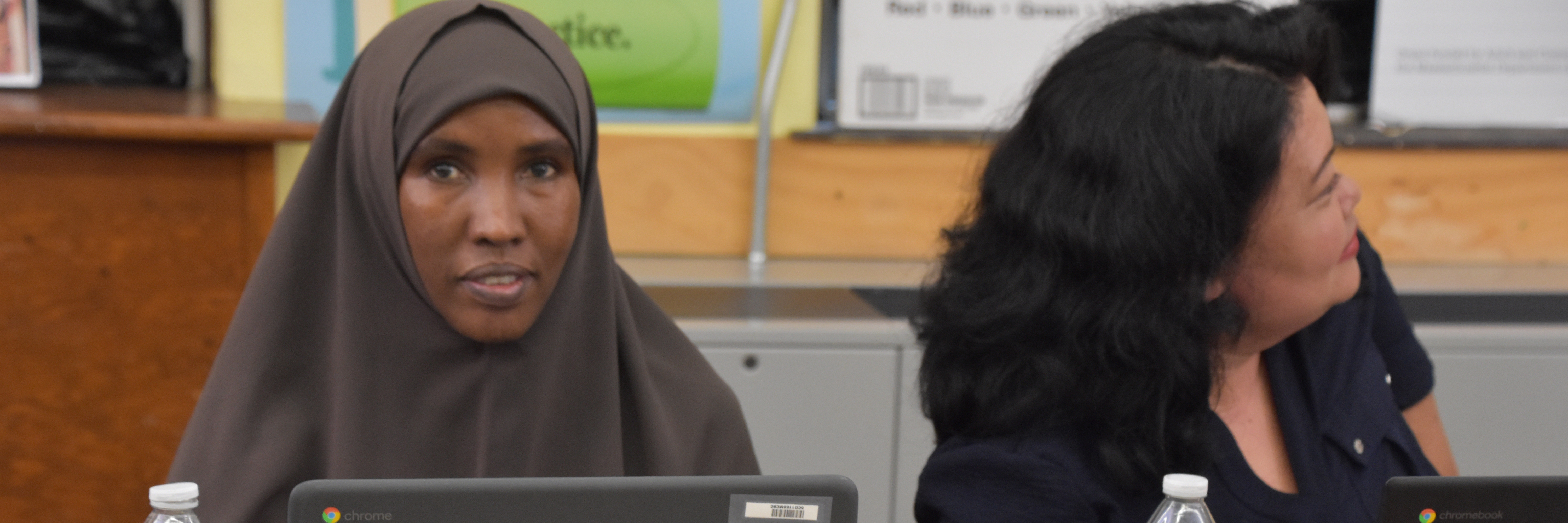 Two adult education students sitting at a table