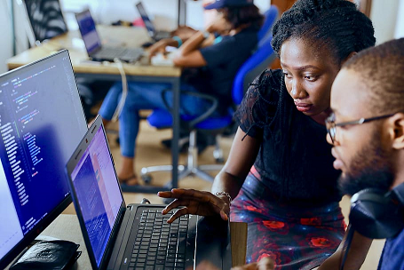 A learner and teacher work at a computer