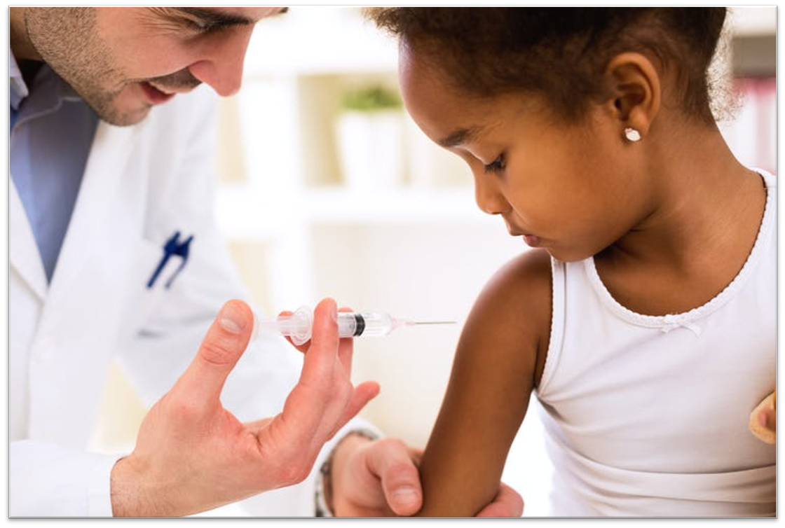 girl receiving injection in arm from doctor
