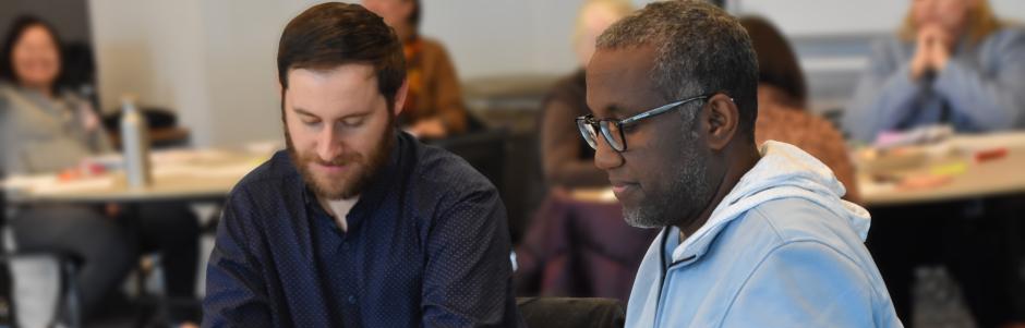 2 adult ed instructors during a PD session.