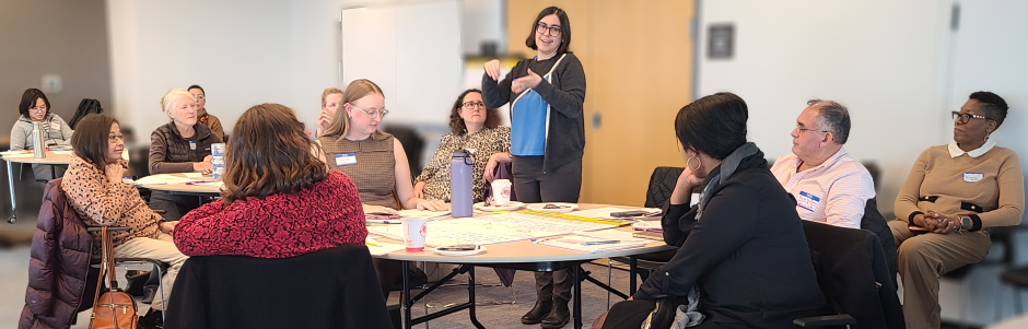 Adults in a class listen to Pesha Black