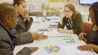 EL students and teacher use math manipulatives