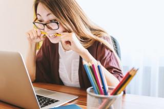 anxious woman looking at computer